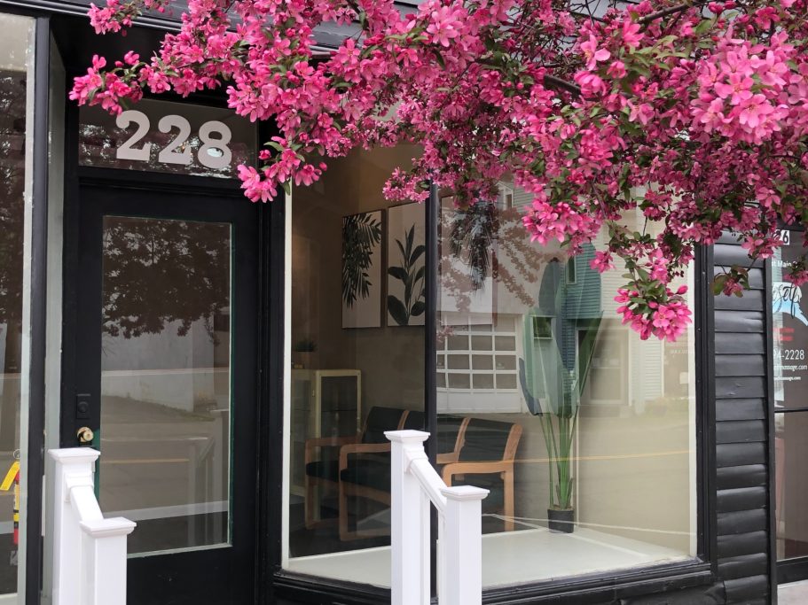 Storefront 228 W. Main Image of storefront on 228 W. Main St with pink tree and white railing.